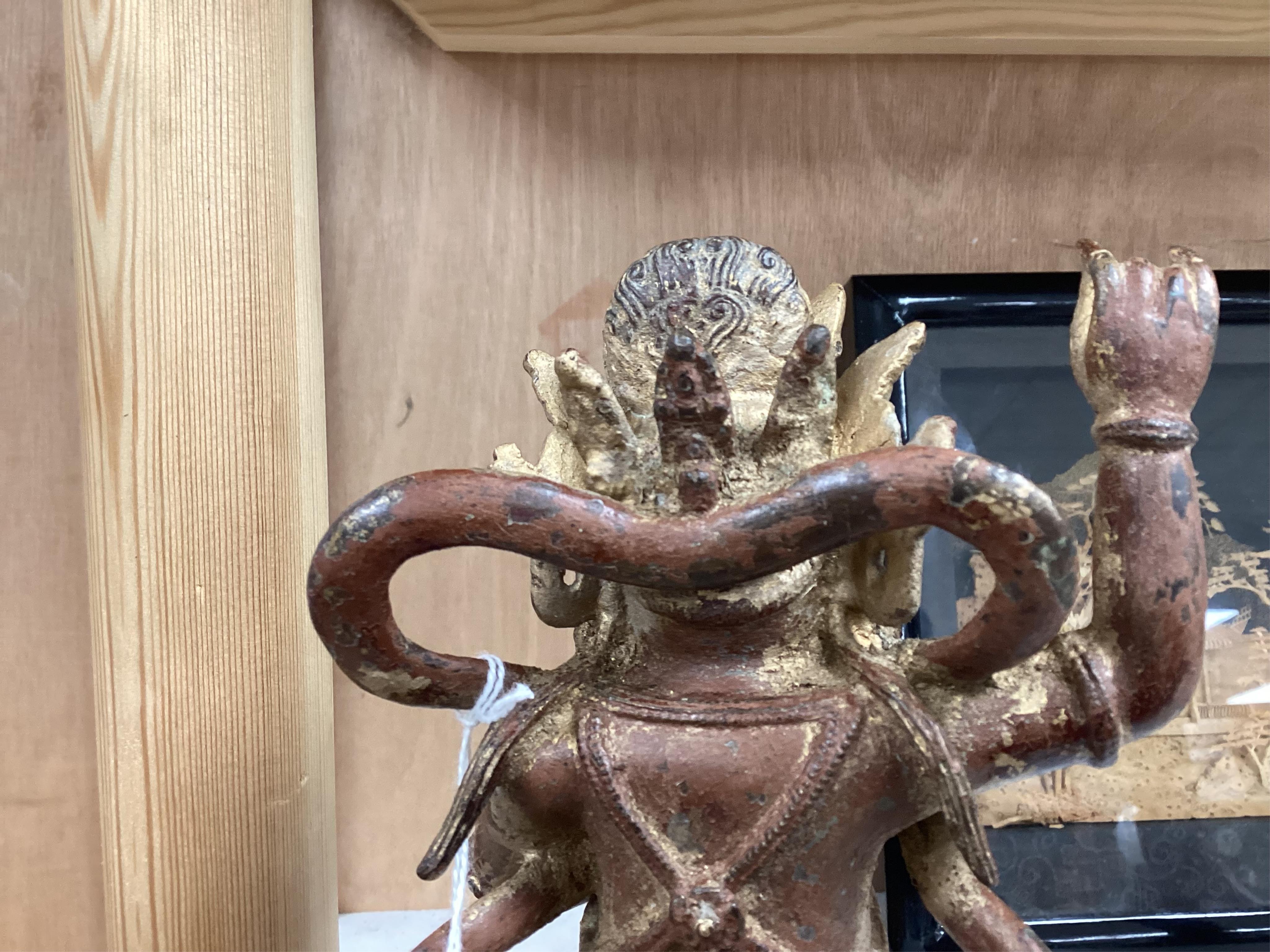 A Buddhist gilt bronze figure of Vaishravana, possibly Tibetan, 21 cm including wooden stand.
